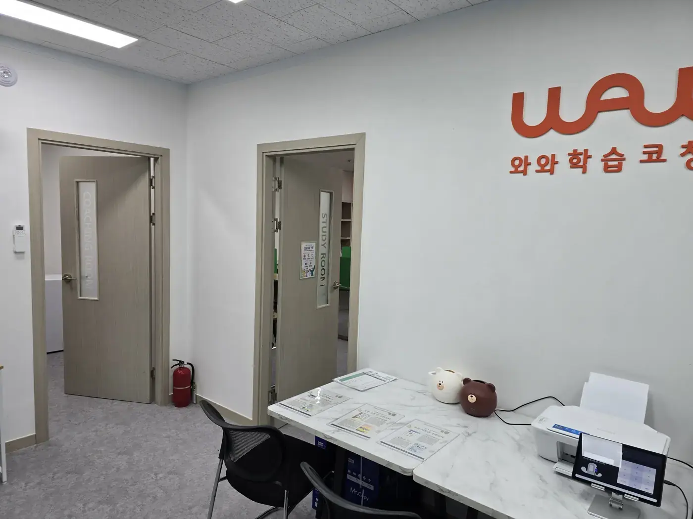 COACHING ROOM·STUDY ROOM 문과 대리석 무늬 상담 테이블이 있는 교하점 로비